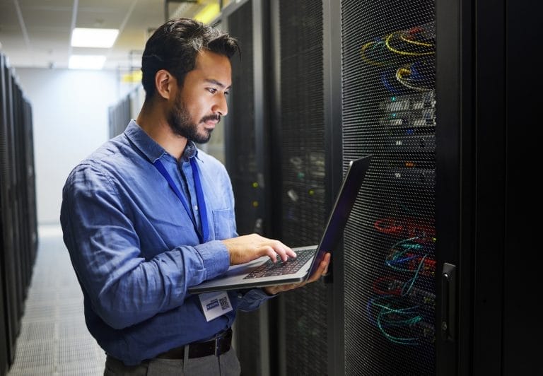 Man, engineering laptop and data center, server room inspection or system solution, coding and business network. IT person on computer for tech upgrade, gdpr programming and hardware problem solving