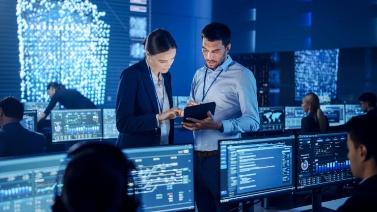 Project Manager and Computer Science Engineer Talking while Usin