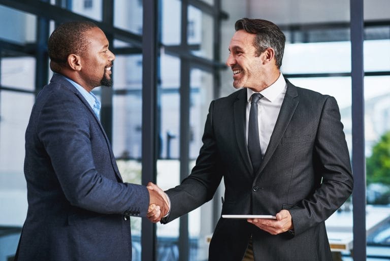 Happy business people, investor or handshake in office for meeting, partnership or greeting at law firm. Diversity, welcome or corporate lawyer with client for deal negotiation, support or consulting